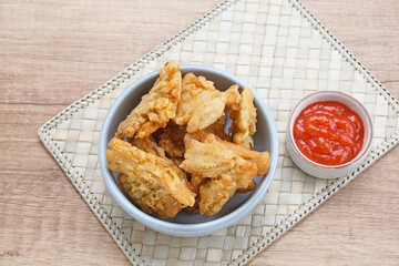 Crispy Fried Oyster Mushroom or Jamur Krispi served with chilli sauce, Indonesian snack
