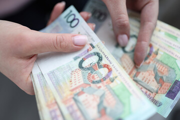 One hundred Belarusian rubles banknotes in female hands