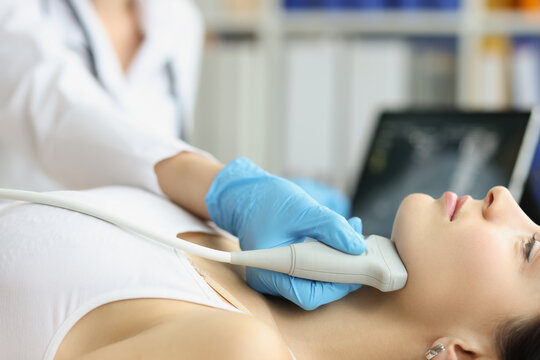 Doctor diagnoses thyroid gland on ultrasound machine closeup