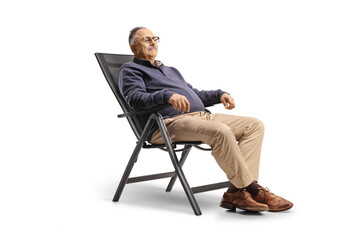 Mature man resting seated in a foldable chair