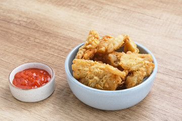 Crispy Fried Oyster Mushroom or Jamur Krispi served with chilli sauce, Indonesian snack
