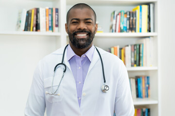 Portrait of black mature adult doctor at office