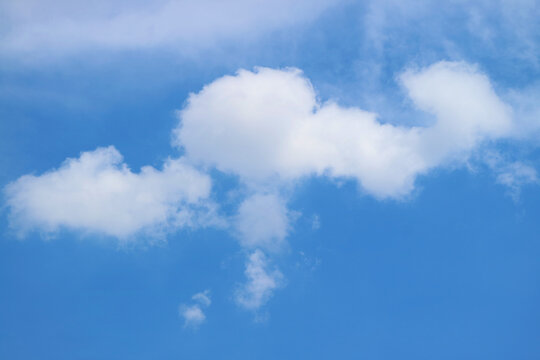 White Fluffy Clouds Floating on Bright Blue Sky © jobi_pro