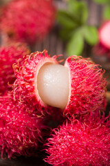 fresh ripe rambutan fruit on wooden table