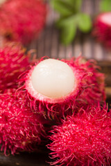 fresh ripe rambutan fruit on wooden table