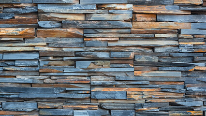 Background and texture of multicolor cladding stone slate wall in loft style