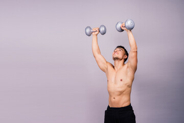 Shirtless bodybuilder showing his great body and holding dumbell.