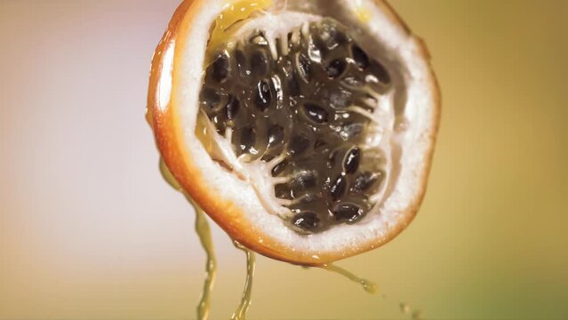 Slow Motion Macro Shot of Flowing Granadilla Juice from Halved Granadilla