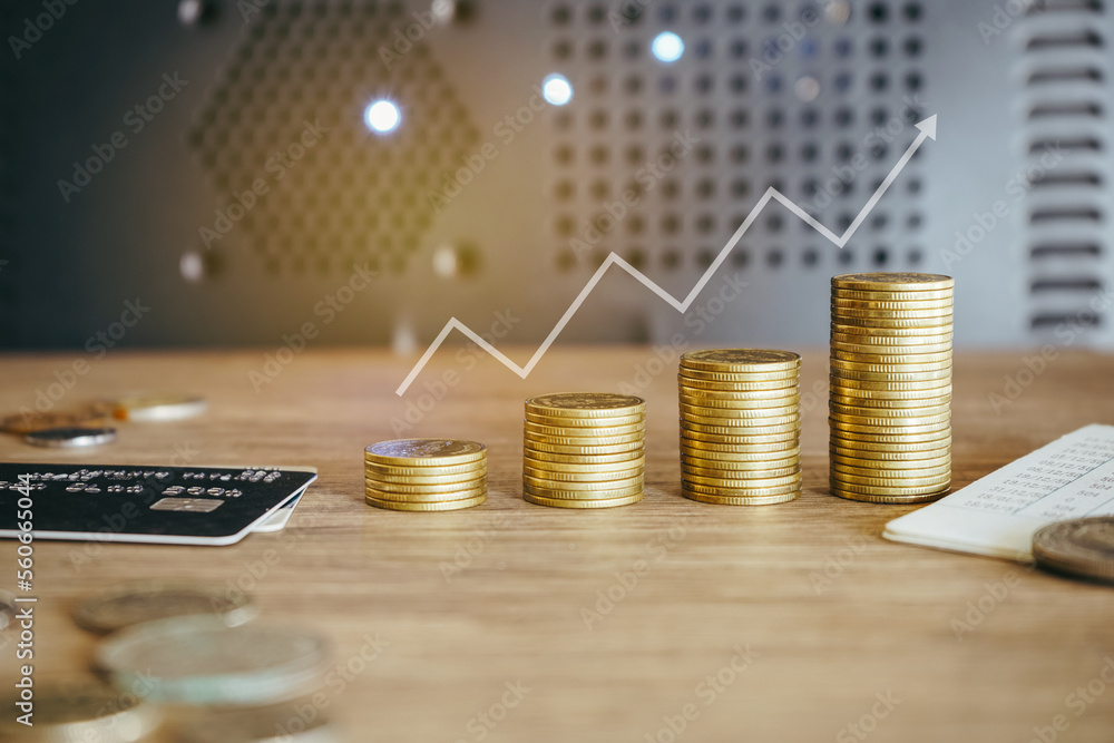 Wall mural stack of golden money coin on office desk. business and financial concept.