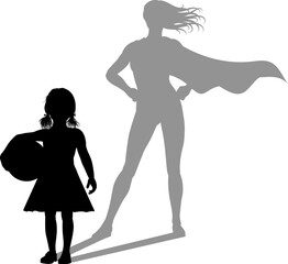 A superhero child or kid girl revealed by her shadow silhouette as a super hero in a cape.