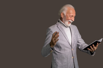 Senior businessman looking at his notebook happy
