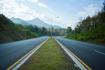 Road is a road for cars to drive. Surrounded by natural mountain trees