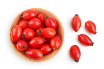 Rose hip in wooden bowl isolated on a white background with full depth of field. Top view. Flat lay
