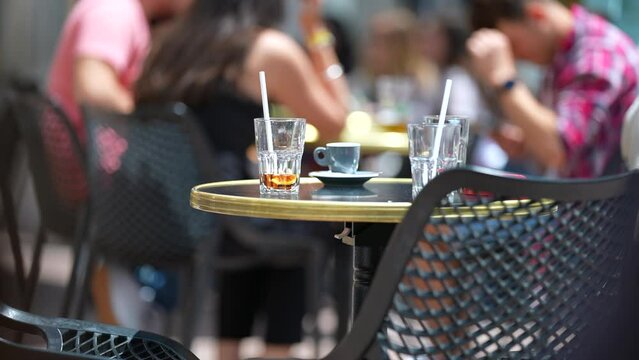 Restaurant leftovers in exterior empty table with cups and straws