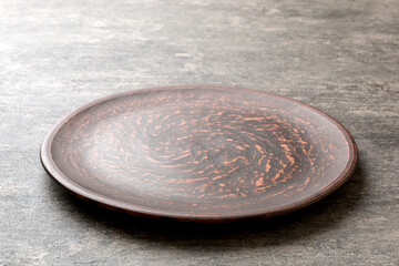 Perspective view of empty plate on cement background. Empty space for your design