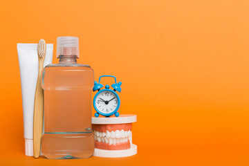 Mouthwash and other oral hygiene products on colored table top view with copy space. Flat lay. Dental hygiene. Oral care kit. Dentist concept