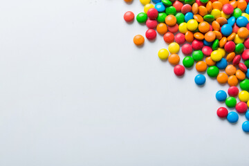 Mixed collection of colorful candy, on colored background. Flat lay, top view. frame of colorful chocolate coated candy