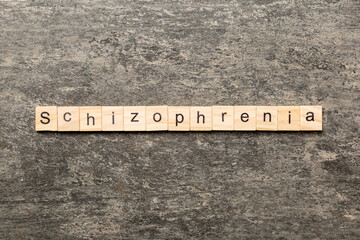 schizophrenia word written on wood block. schizophrenia text on table, concept