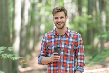 Naklejka na ściany i meble happy caucasian man with coffee wearing checkered shirt. photo of caucasian man