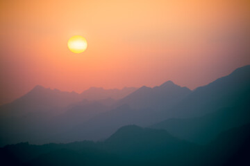 The hazy sun above the mountain tops. View of the mountains in the afternoon. Buyan Pavilion, Shuangxi District, New Taipei City. Taiwan