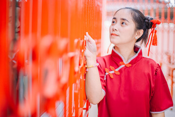 Asian woman in cheongsam on the Chinese New Year festival.