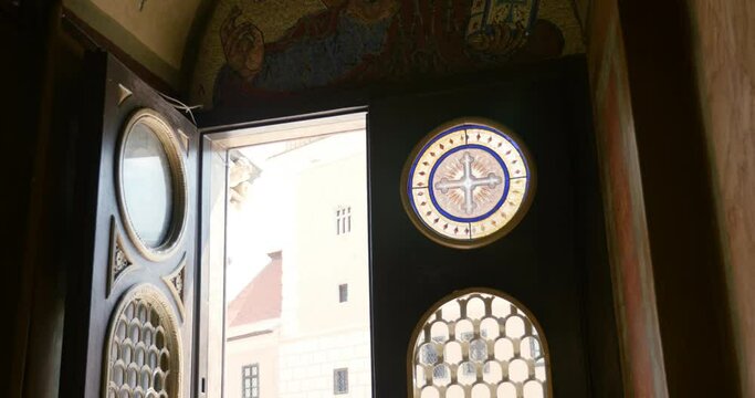 Entrance to Biserica Sfanta Adormirea Maicii Domnului Church of the Holy Dormition of the Mother of God zoom out to old fresque with Jesus face holding a bible