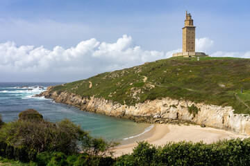 Fototapeta na wymiar Hercules tower roman lighthouse since Lapas beach in the city of A Coruña in a sunny day, Galicia, Spain.