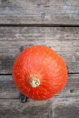 bright orange pumpkin on wooden background.