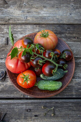 fresh tomatoes and cucumbers on a plate