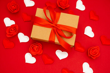 Gift box on the red background. Red ribbon. The concept of the day of St. Valentine's, weddings, birthday and other holidays