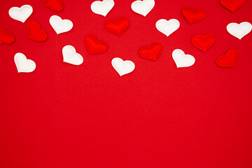 Many hearts on a red background. Festive background. Background for design. Place for text, banner, top view