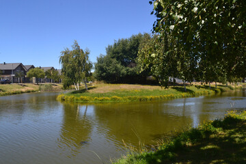 Fototapeta na wymiar a beautiful river near a housing estate in the summer time