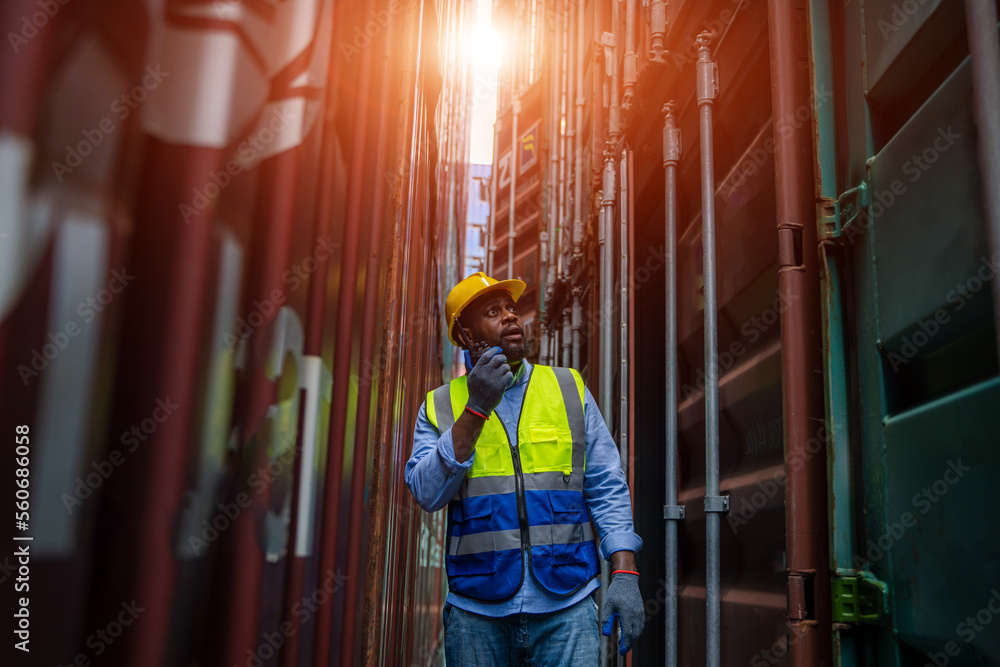 Poster Engineer using walkie talkie checking stock into container for loading,International shipping logistics.