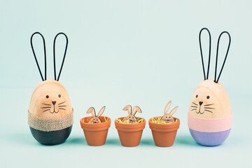 Cute easter bunny family, rabbit baby in a flower pot, spring holiday greeting card
