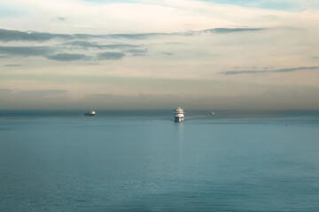 Cruise ship sailing on the Mediterranean Sea with a silhouette sunrise sky