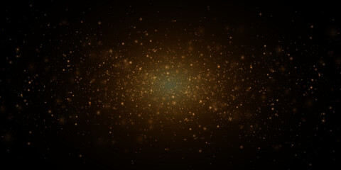 Christmas festive background of light confetti and small shining golden lights on a black background. Shiny golden texture.