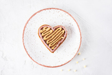 Heart shaped gingerbread on a plate. Healthy food, sugar, gluten and lactose free.