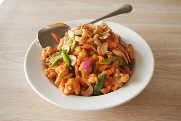 Salad with fresh vegetables and nuts in a bowl on table 