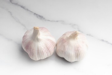 Bulbs of garlic on white rustic wood table