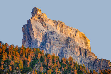 Magical nature, Alps mountains and forest in Dolomites at the national park Three Peaks, during golden Autumn, South Tyrol, Italy, with blue sky at sundown