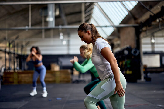Fit women doing an exercise class in a gym
