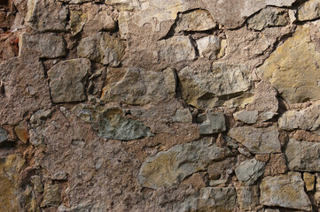 stone wall, in the photo an old brown stone wall close-up