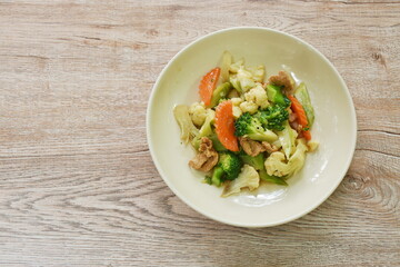 stir fried cauliflower and broccoli with pork in oyster sauce on plate 