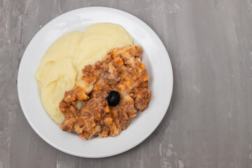 Minced meat and mashed potato on white plate