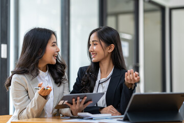 Asian female sales representatives in the section of Real estate talked and discussed tax plans to search for information Ask questions and give advice. All information is recorded and detailed.