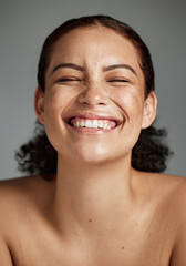 Face, beauty and funny with a model black woman in studio on a gray background laughing for skincare. Facial, wellness and makeup with an attractive young female happy with her skin product