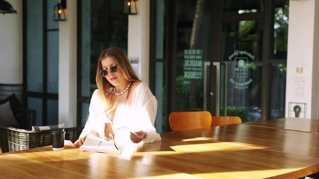 woman flip magazine in cafe