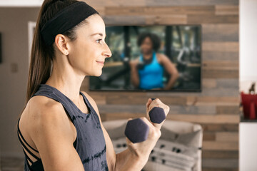 Home: Woman Uses Weights During Virtual Class