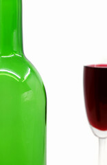 glass of red wine with bottle isolated on white background