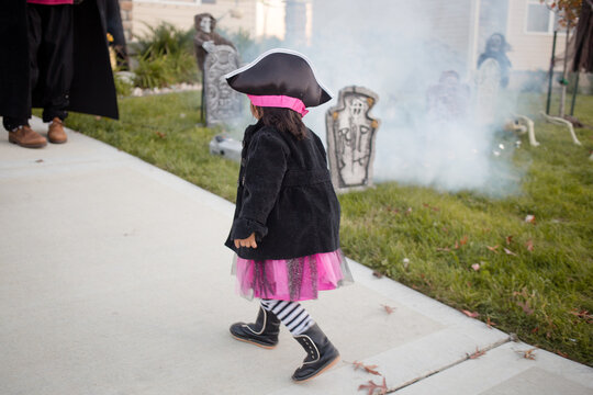 Pirate costume girl trick or treating at spooky house